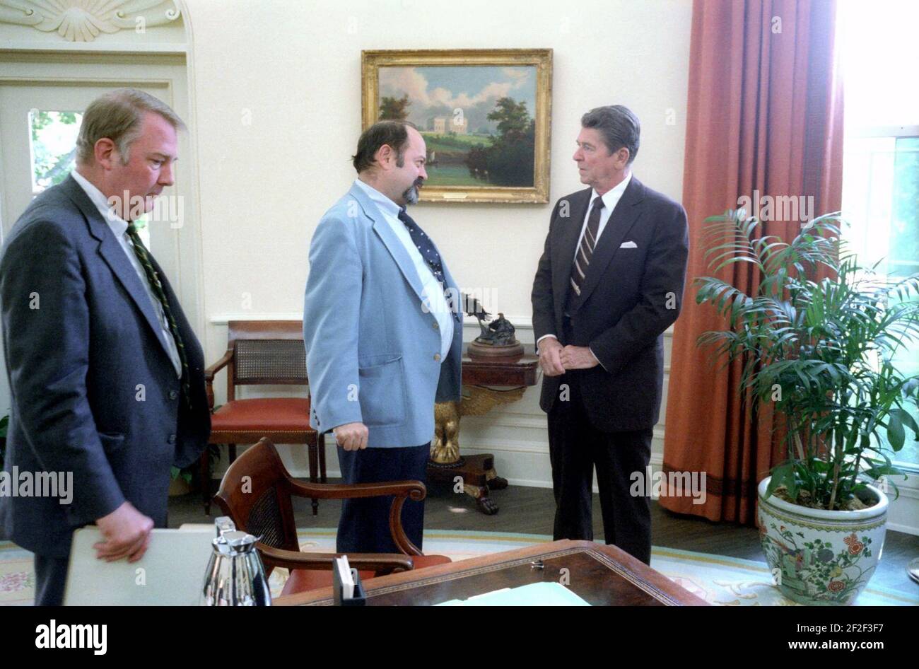 President Ronald Reagan talking with Lyn Nofziger with Ed Meese at left ...