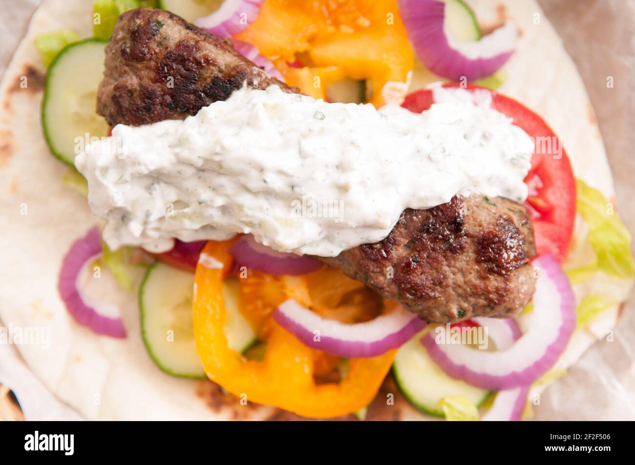 delicious flatbread wrap koobideh, iranian skewer with fresh vegetables