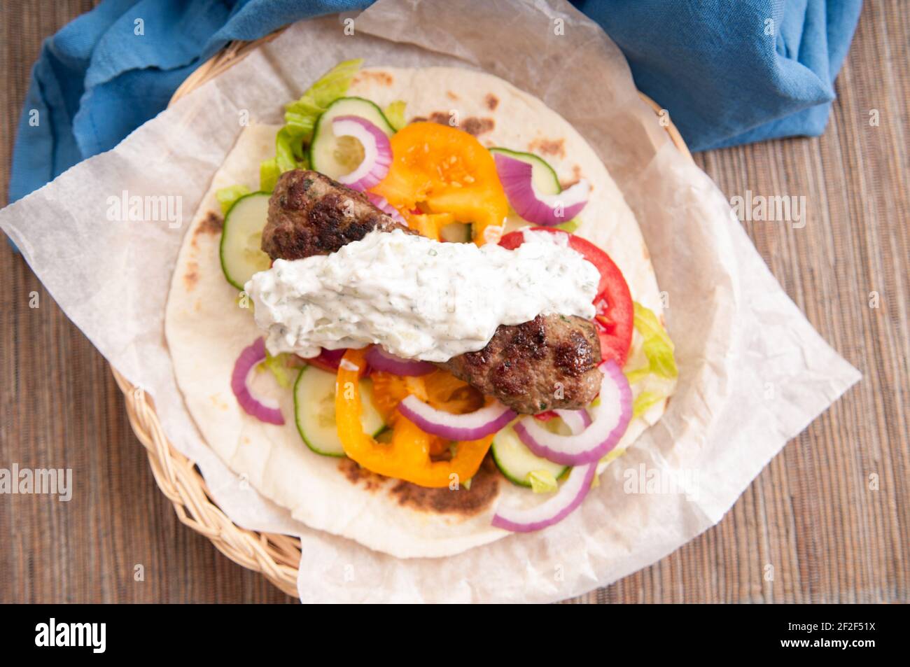 delicious flatbread wrap koobideh, iranian skewer with fresh vegetables