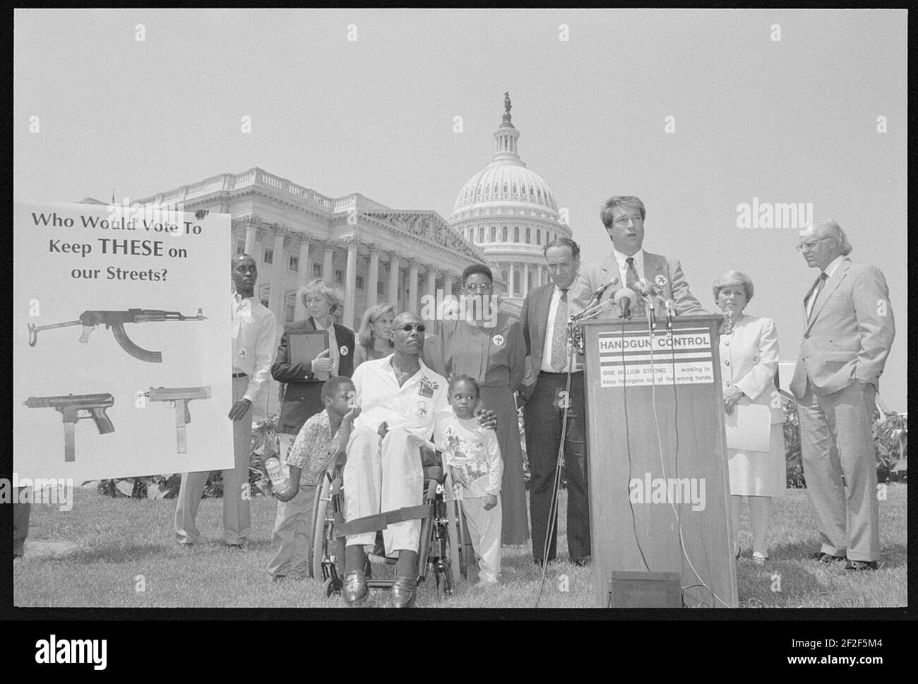 Press conference on the crime bill outside of the U.S. Capitol showing President of Handgun Control, Inc., Richard Aborn; victim of gun violence Ronald Shepperson and family, and Representatives Christopher Shays and Margaret Roukema. Stock Photo