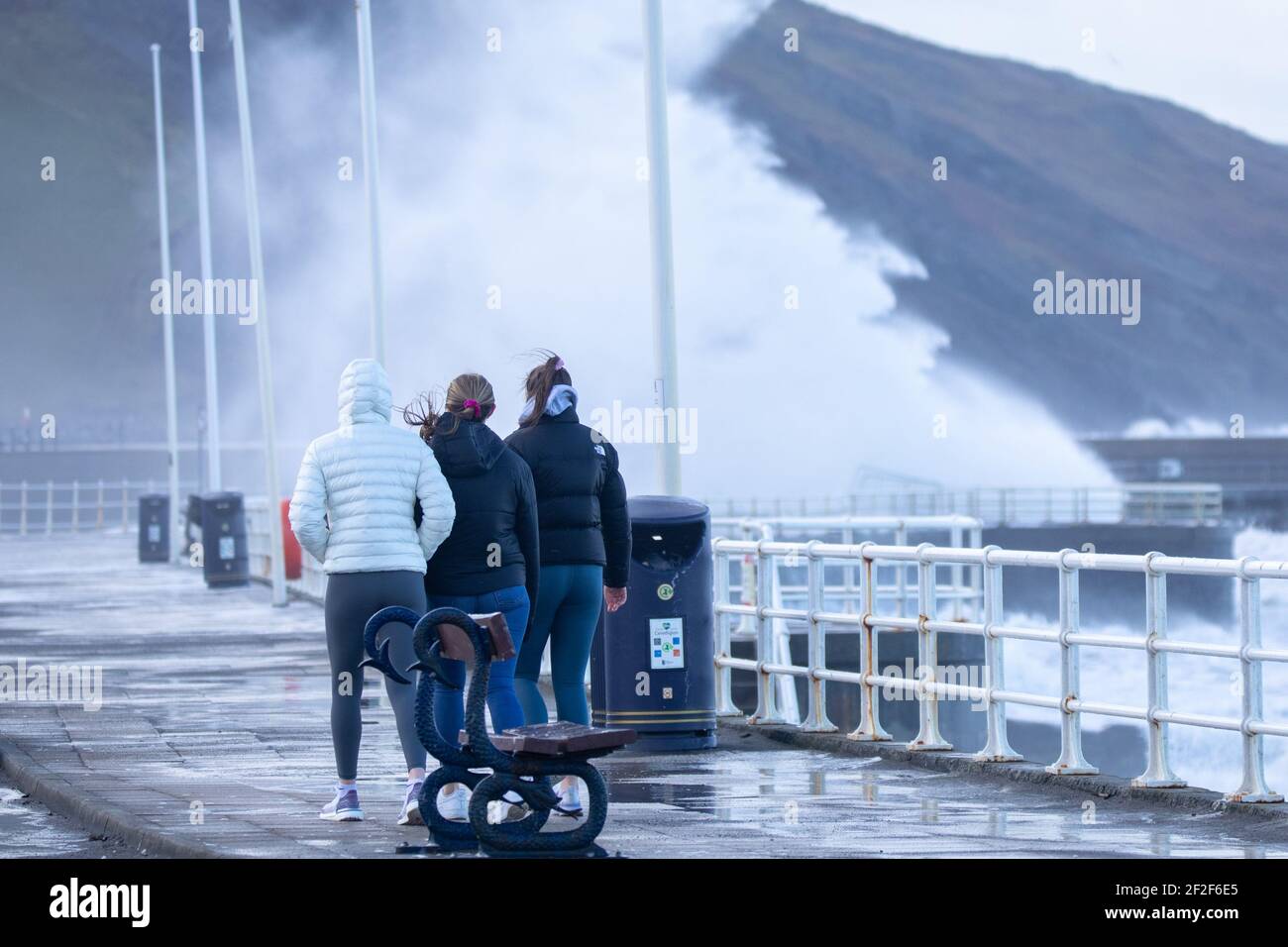 Aberystwyth, Ceredigion, Wales, UK. 12th March 2021 UK Weather: Gusty westerly Winds continue this morning as it combines with high tide, creating huge waves against the sea defences in Aberystwyth. © Ian Jones/Alamy Live News Stock Photo