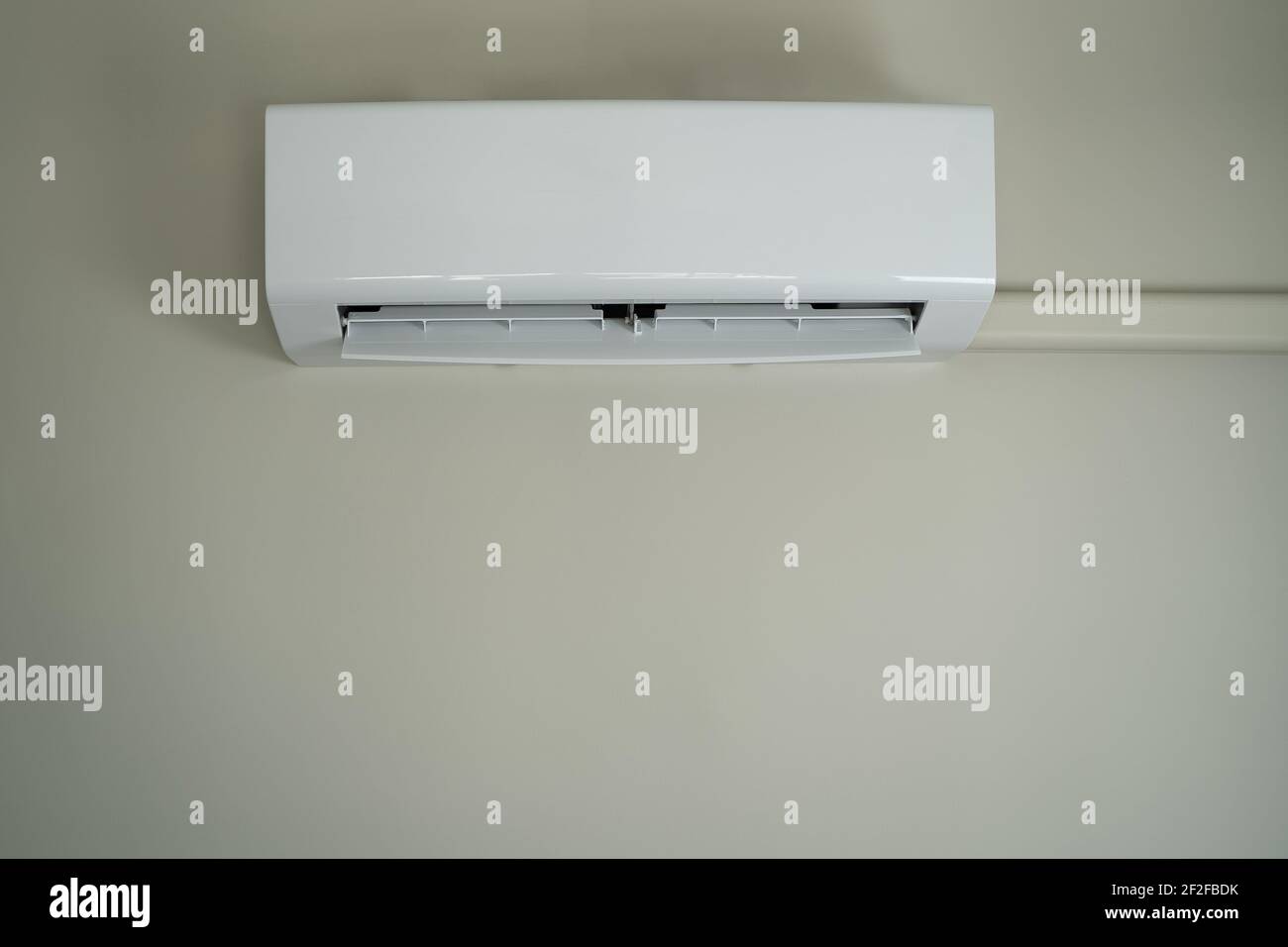 Air conditioner inside top the room man operating remote controller open air conditioner energy savings Stock Photo