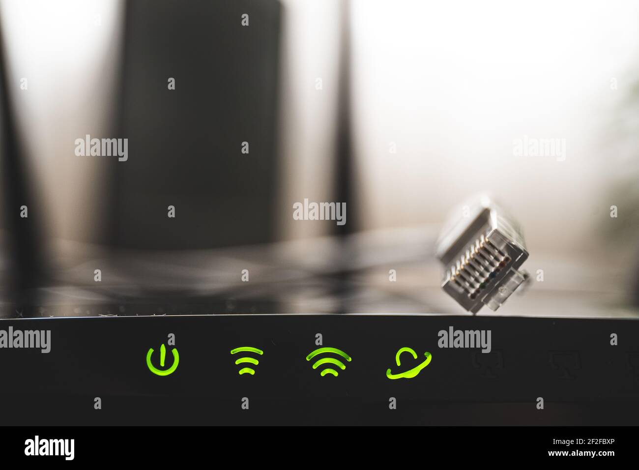 Close up shot of router and green icons of WIFI connection