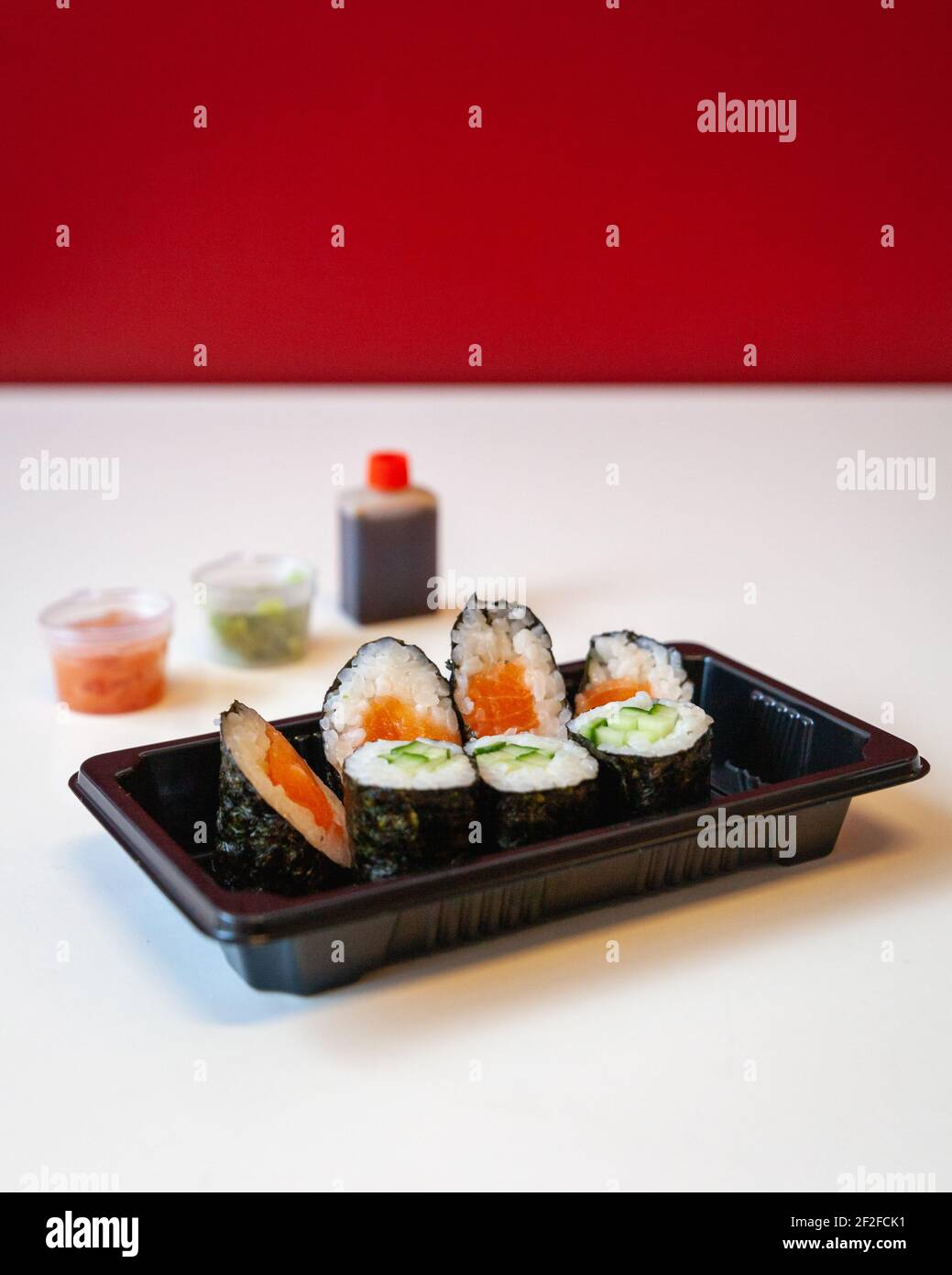 Side view of fresh take away Japanese sushi with chop stick, pickled