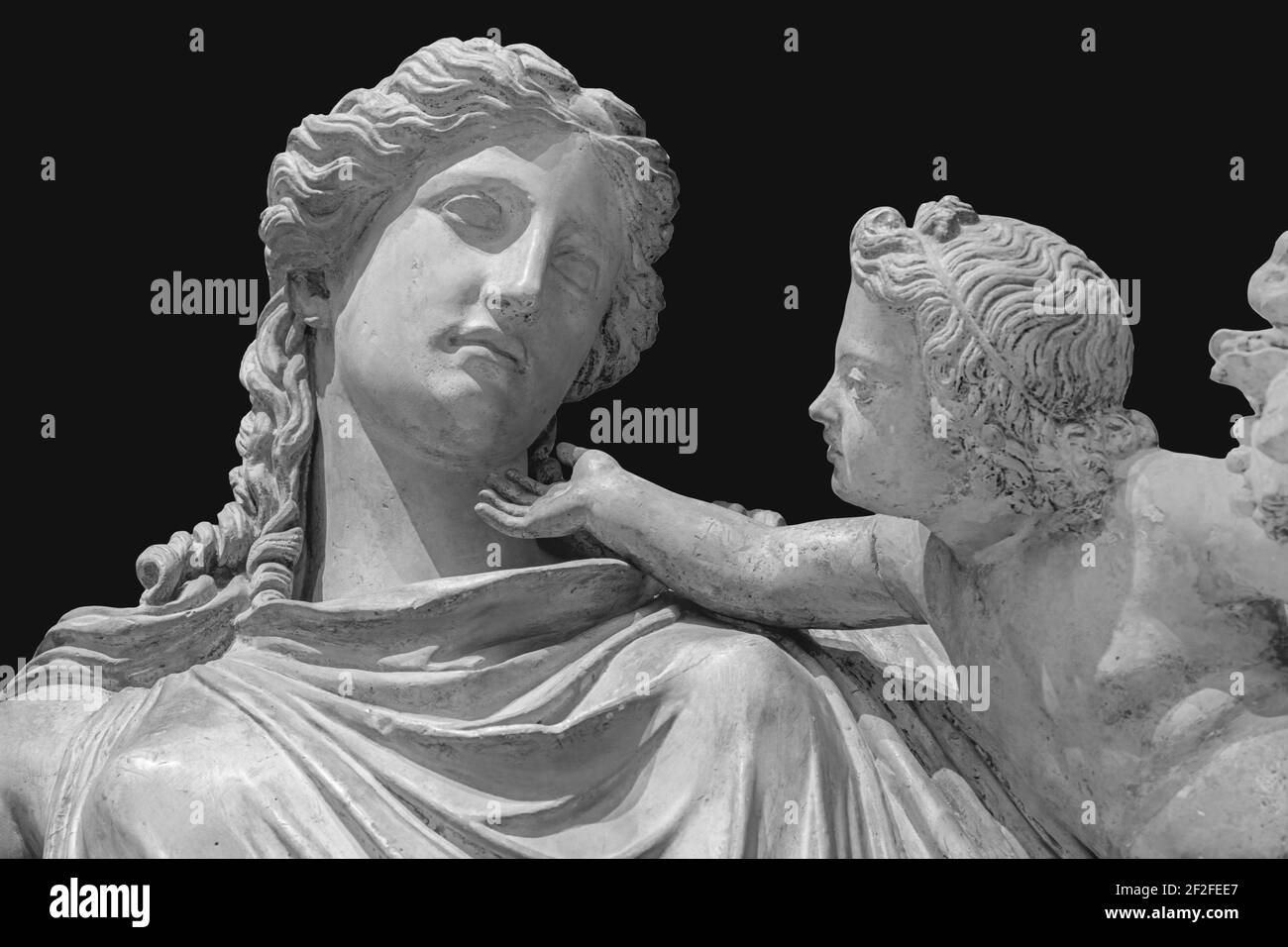 Antique statue of Eirene with the infant Ploutos isolated on black background. Goddess of Peace beautiful young woman carrying a cornucopia Stock Photo
