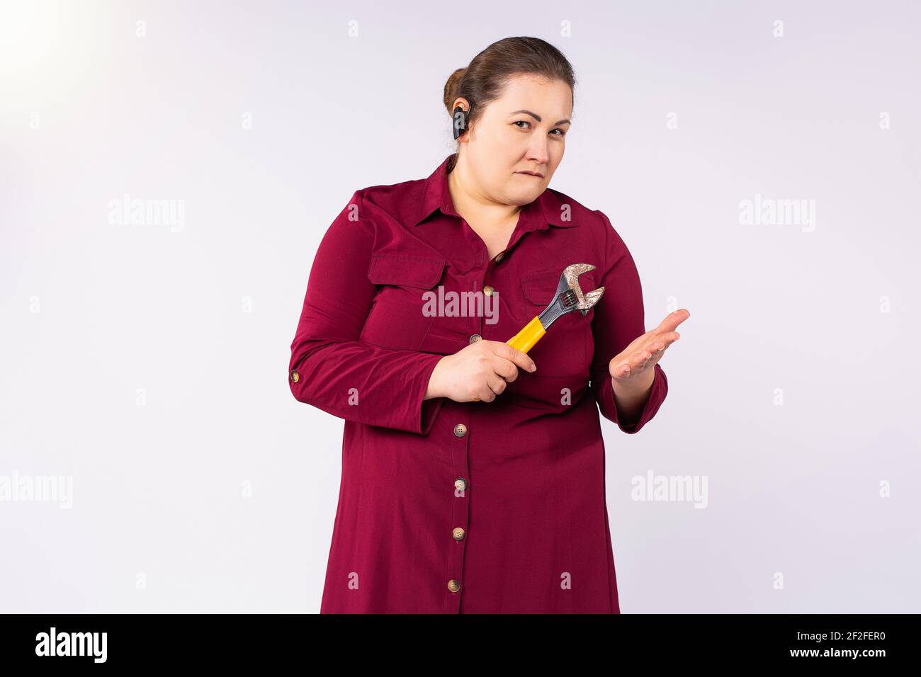 Large size portrait of female engineer. Focused looking at the camera. Gray background with empty space. Stock Photo