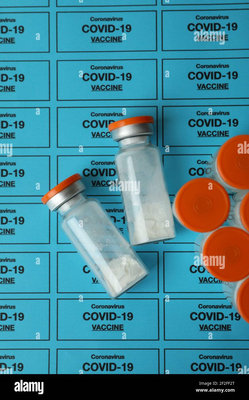 Vials of powder Covid - 19 vaccine on blue background Stock Photo - Alamy