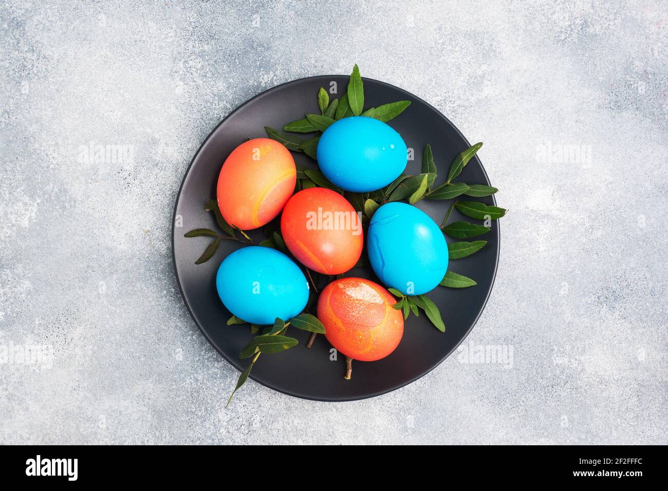 Easter eggs painted by hand colored on a concrete table, top view copy space Stock Photo