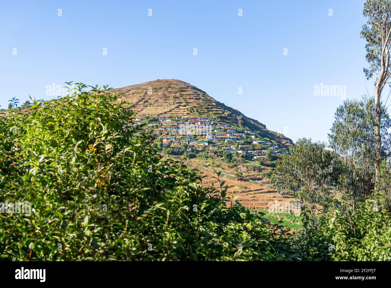 colorful mountain village on a slope in Tamil Nadu, India Stock Photo