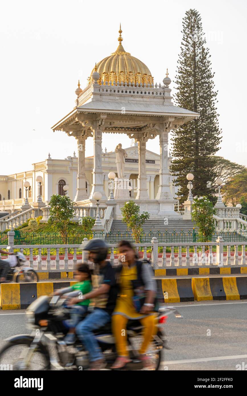 Motorcycles ride at the intersection in front of palace in Mysore, India Stock Photo