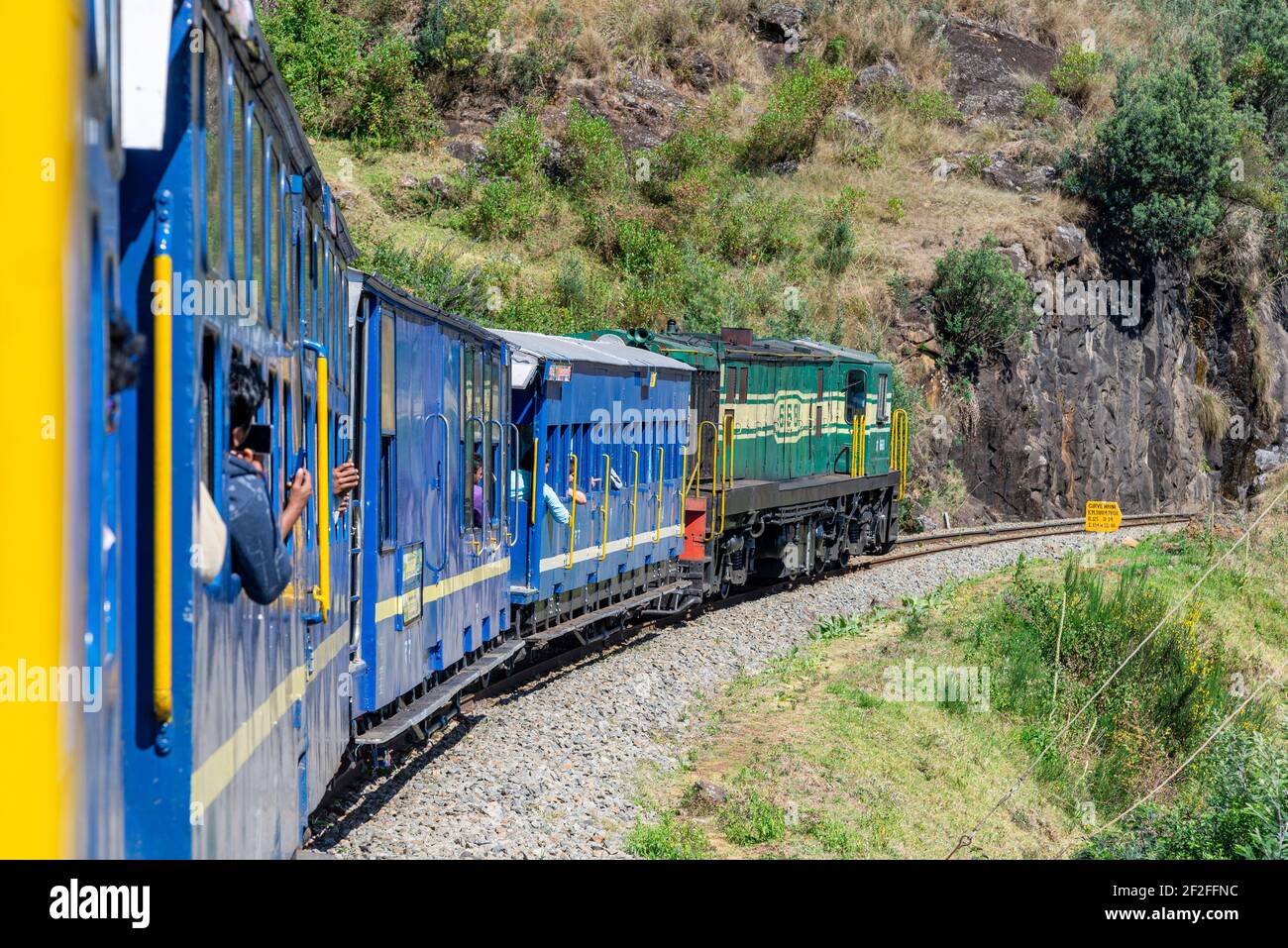 Blue Mountain Train drives along a slope, Tamil Nadu, India Stock Photo