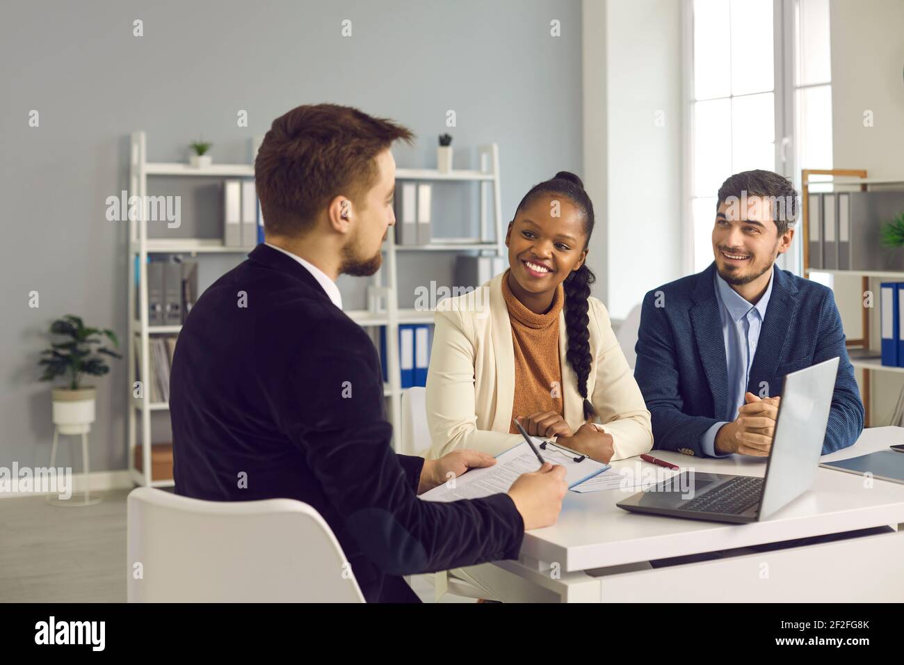 Financial manager, realtor or insurer consulting clients in modern office Stock Photo