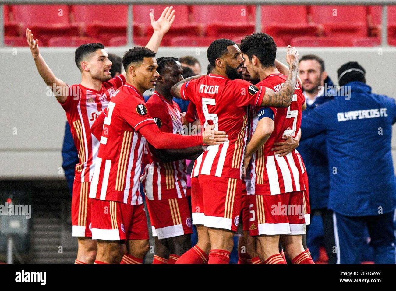 Olympiacos players celebrate after team-mate Youssef El Arabi scores their side's first goal of the game during the UEFA Europa League Round of Sixteen match at the Karaiskakis Stadium, Greece. Picture date: Thursday March 11, 2021. Stock Photo
