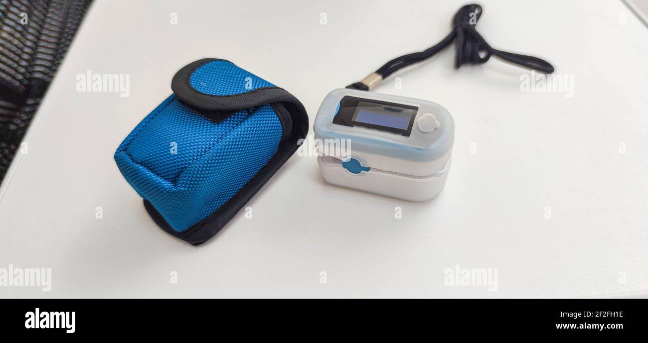 Oximeter apparatus. Protective case on white surface. Equipment for
