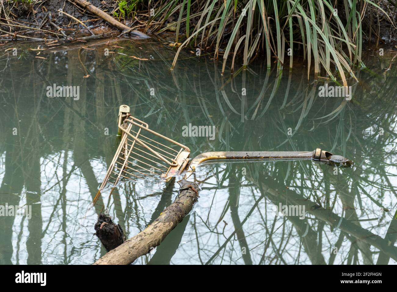 Shopping trolley or cart dumped in a river, UK Stock Photo