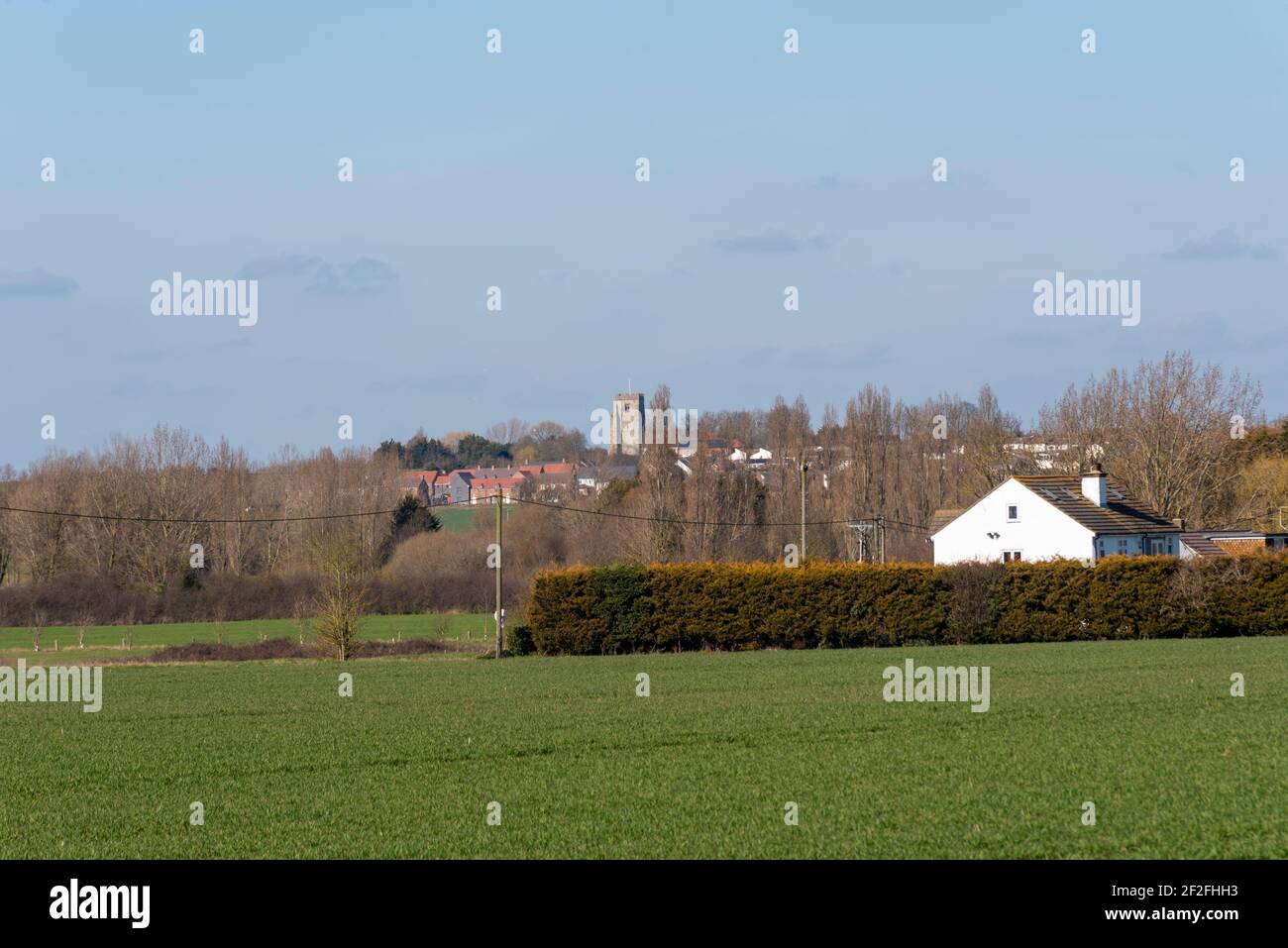 Church of St. Nicholas in Canewdon high on a hill viewed from fields near Stambridge, Essex, UK. British, English countryside. Village church Stock Photo
