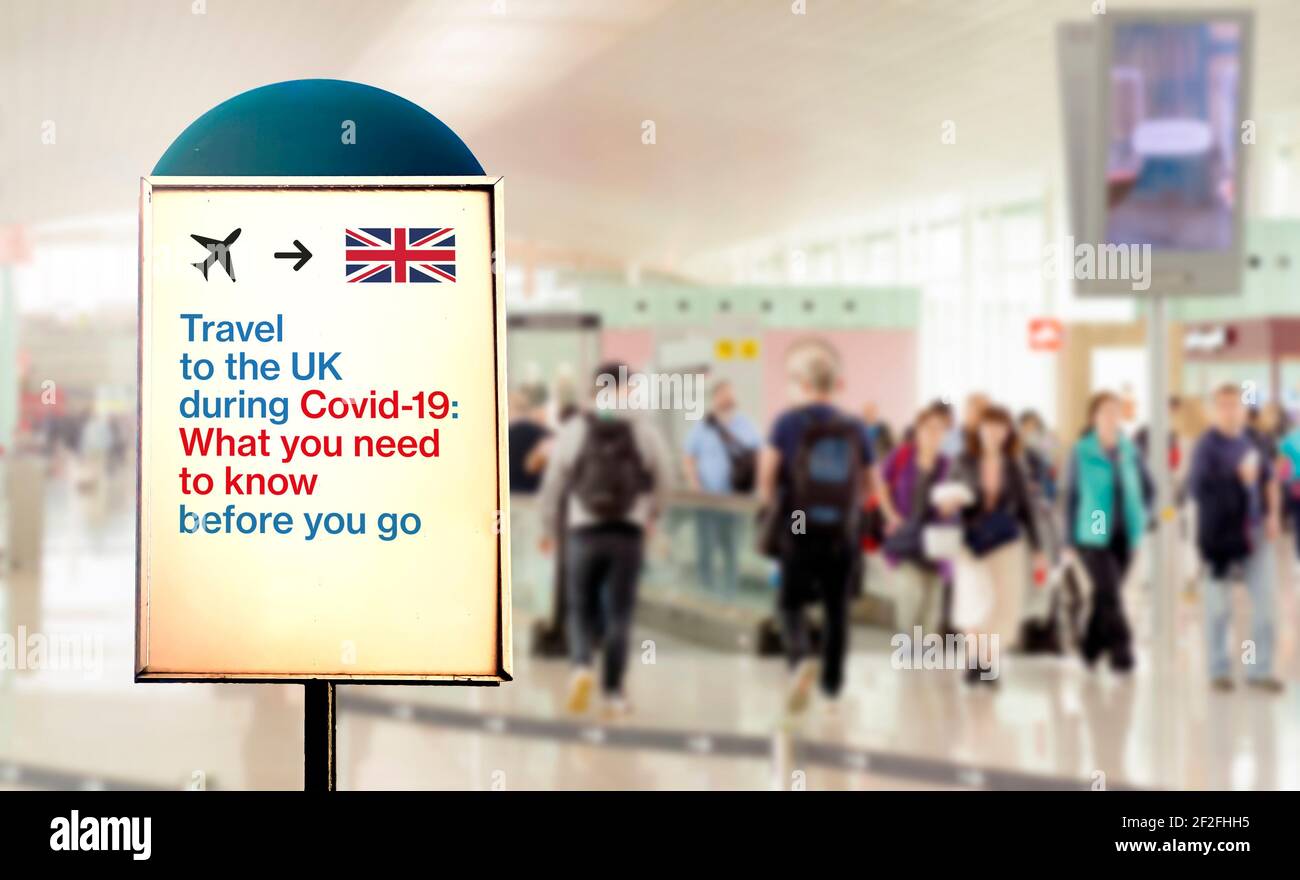 a signal inside an airport that warns about what to know before flying to England during the Covid-19 pandemic. Airport security measures and travel r Stock Photo