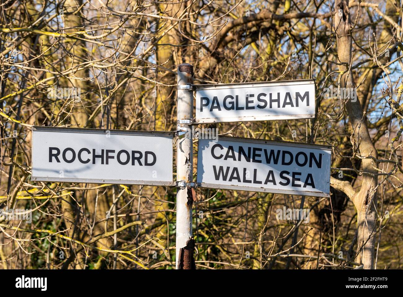 Old road destination sign in Ballards Gore, Stambridge, Essex, UK, with routes to Rochford, Paglesham, Canewdon and Wallasea. Woodland country Stock Photo