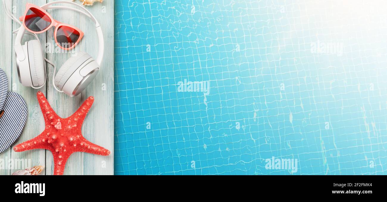 Pool and beach items and water surface of swimming pool. Travel and vacation concept. Top view flat lay with copy space Stock Photo