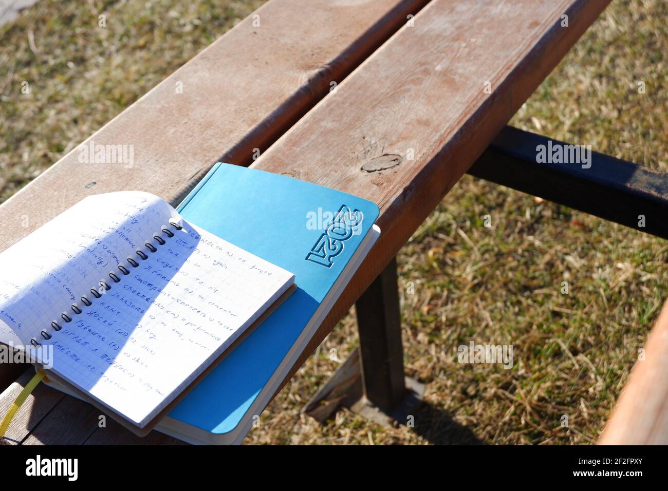 Opened notebook and Agenda on Wooden Bench Stock Photo