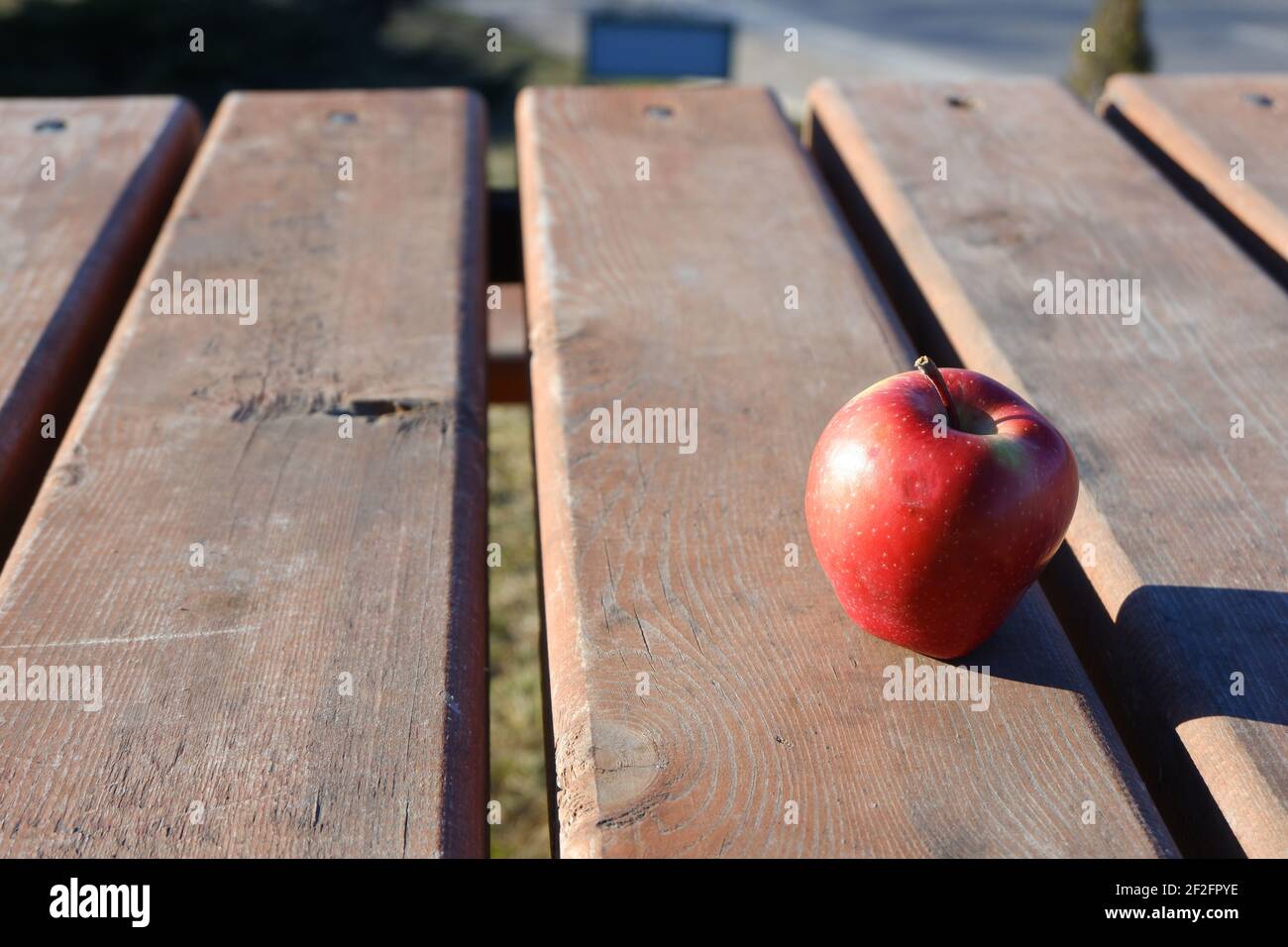 Red apple on wooden table outdoor Stock Photo