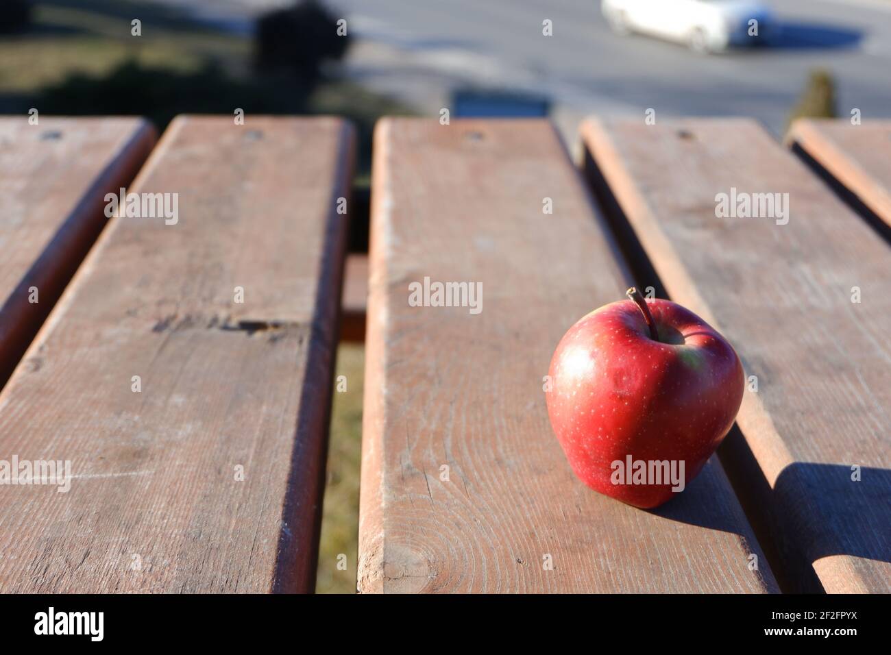 Red apple on wooden table outdoor Stock Photo