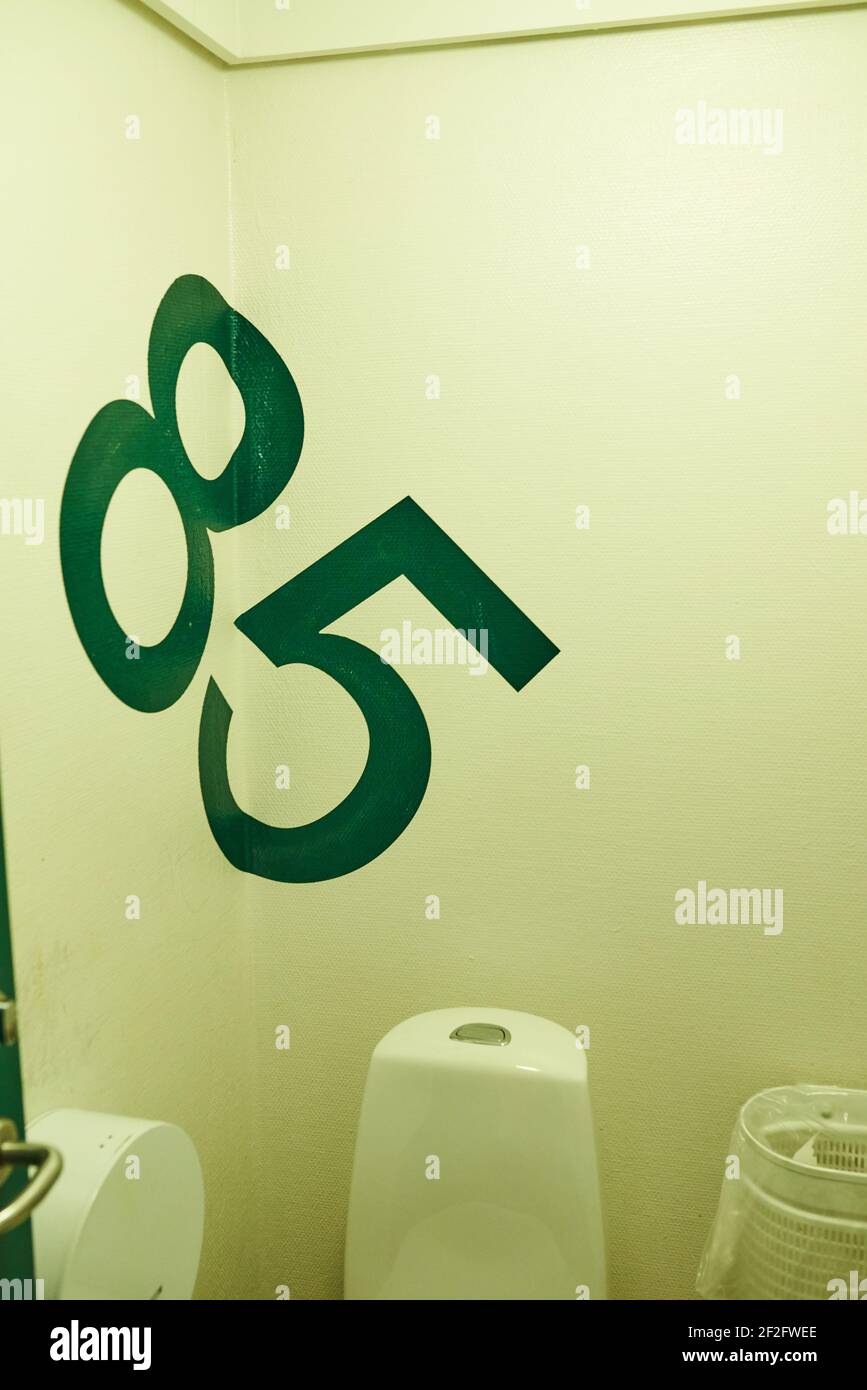 Large numbers on the wall in a green toilet Stock Photo