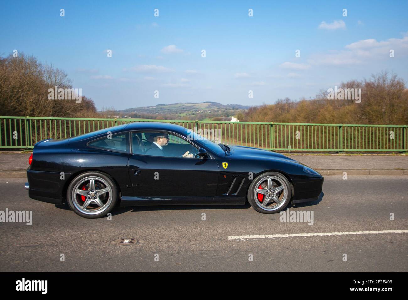 2003 black Ferrari 575M Maranello 5748cc petrol coupe; Rear-wheel drive front-engined supercar, two-seat, two-door, grand tourer. Stock Photo