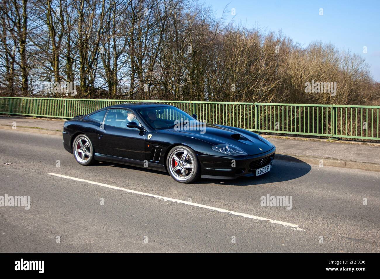 2003 black Ferrari 575M Maranello 5748cc petrol coupe; Rear-wheel drive front-engined supercar, two-seat, two-door, grand tourer. Stock Photo