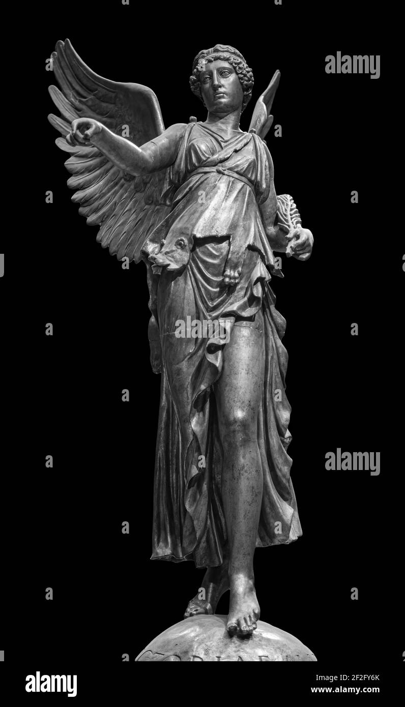 Bronze statue of a Winged Victory. Frontal view of a Statue of the goddess Nike, isolated on black background by clipping path Stock Photo