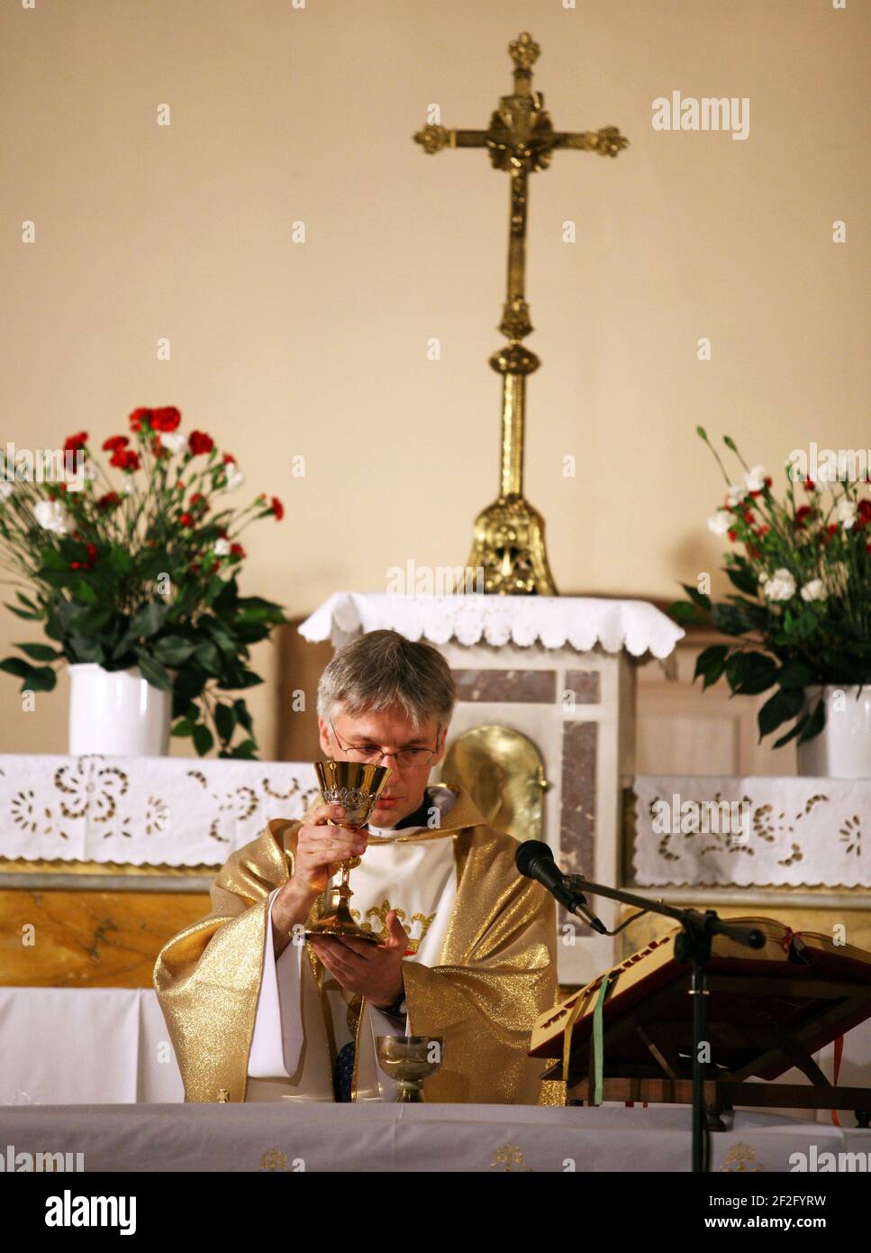 ISTANBUL, TURKEY - MAY 2: Priest, praying to God consecration the bread and wine in Czestochowa's Mother Mary Church on May 2, 2009 in Polenezkoy, Istanbul, Turkey. Stock Photo