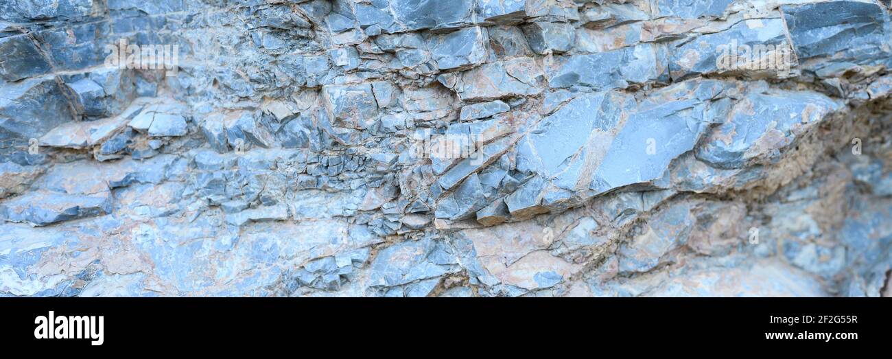 the texture of the surface of the gray blue natural stone rocks as a ...