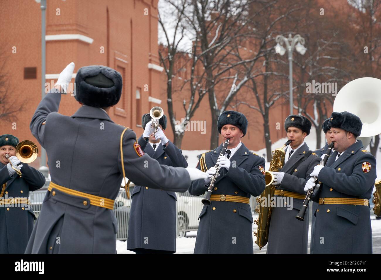 February 4, 2021, Moscow, Russia: Military musicians perform under the direction of a conductor with the brick walls of the Moscow Kremlin in the background during rehearsals ahead of the festival..Every year military bands take part in the ''Spasskaya Tower'' festival. This is a grandiose ''battle'' of the orchestras of the armies of different countries for the love and enthusiasm of the audience, which unfolds against the backdrop of the majestic walls of the Kremlin. The organic combination of military, classical, folk and pop music, parade parades of military bands and dance shows, demonst Stock Photo