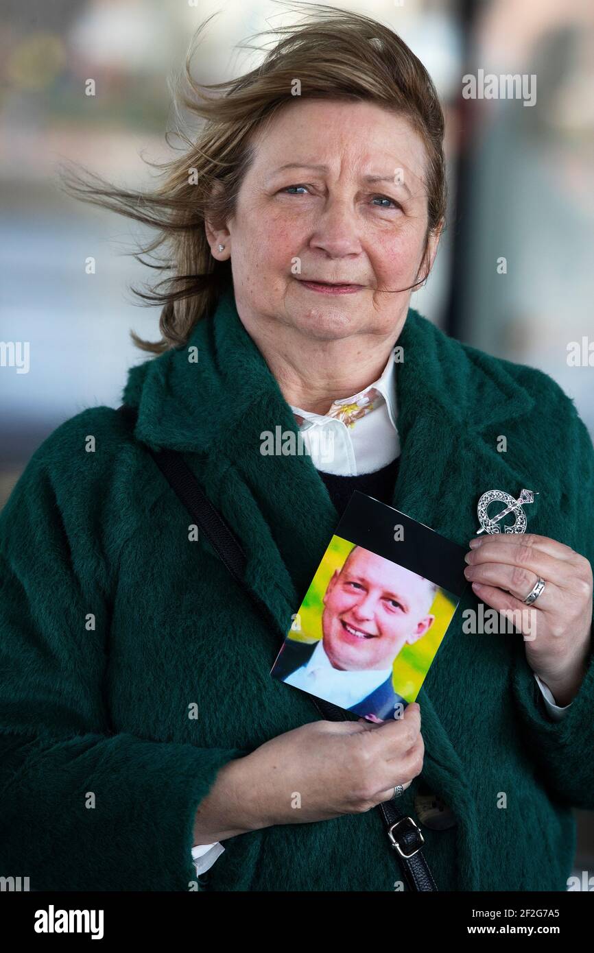 Ella McMahon holds a photograph of her son, Gerard McMahon, outside the International Convention Centre, after a coroner delivered inquest findings surrounding the death of Gerard McMahon after he was restrained by police. A coroner has criticised aspects of a police restraint operation involving the DJ who later died after suffering a cardiac arrest but said the force used by officers was not excessive. Gerard McMahon, from the Short Strand area of Belfast, died in hospital on September 8, 2016. Picture date: Friday March 12, 2021. Stock Photo