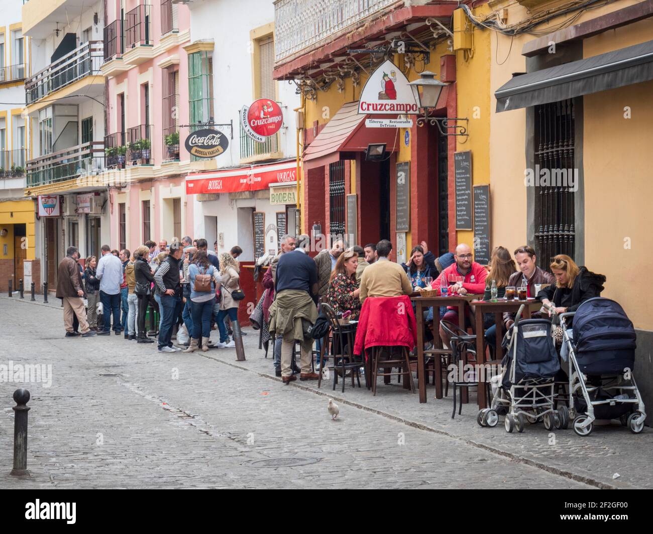 People eating and drinking outside bars and cafes in Triana Seville