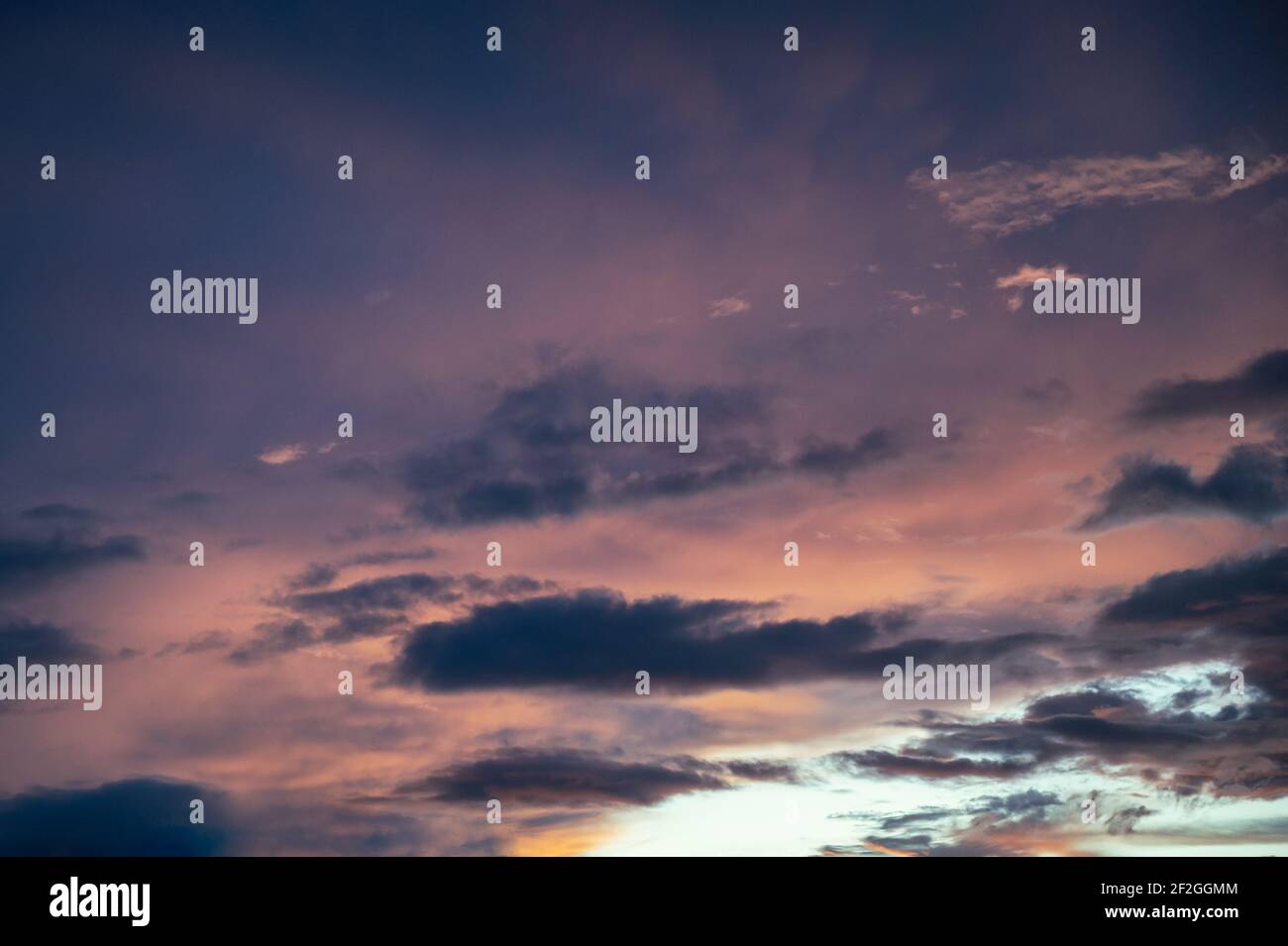 Colorful clouds in dramatic sky at sunset Stock Photo
