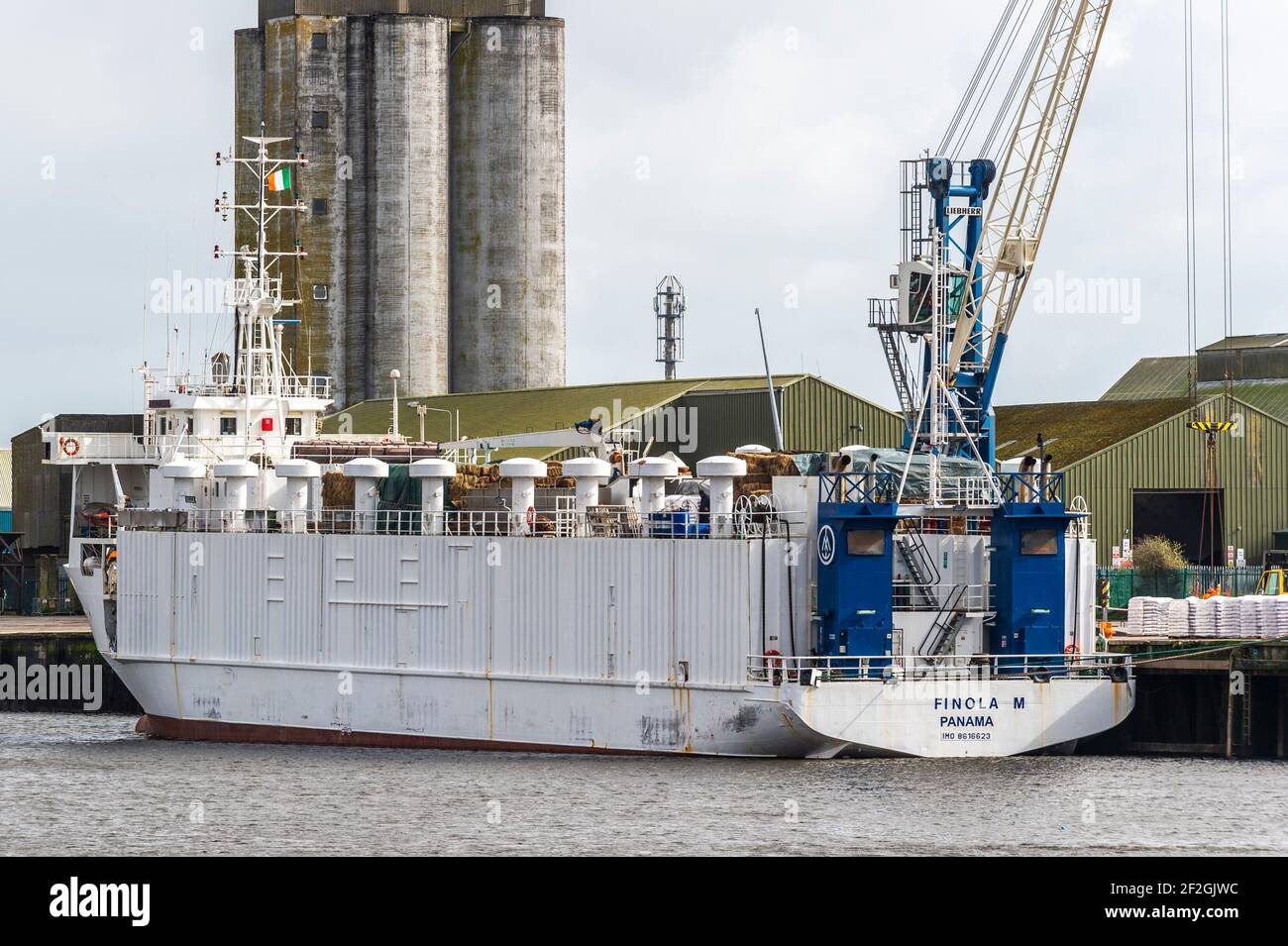 Cork, Ireland. 12th Mar, 2021. The livestock transportation ship 'Finola M' is loaded with feed at Kennedy Quay, Port of Cork, before cattle are loaded tomorrow for export. Credit: AG News/Alamy Live News Stock Photo