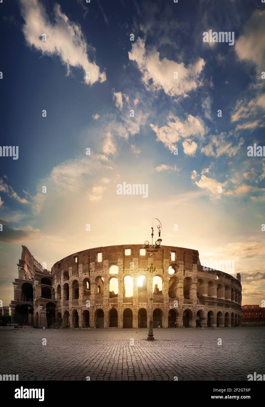 Ancient roman colosseum and sunny sunrise in Rome, Italy Stock Photo