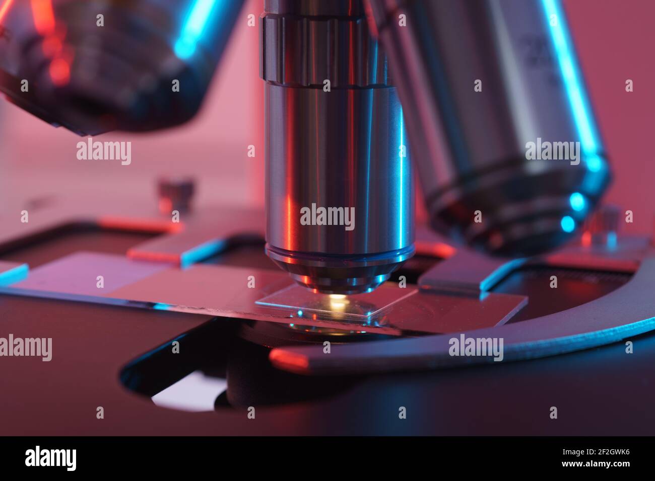 Toned photo of a backlit microscope lens in a science laboratory Stock