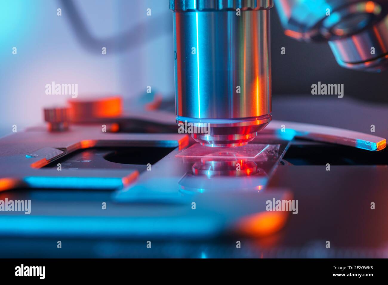 Toned photo of a backlit microscope lens in a science laboratory Stock