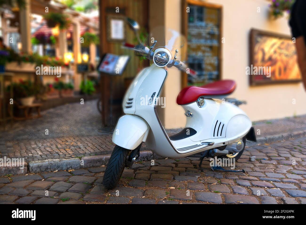 Vintage white scooter parked on the street of Prague Stock Photo