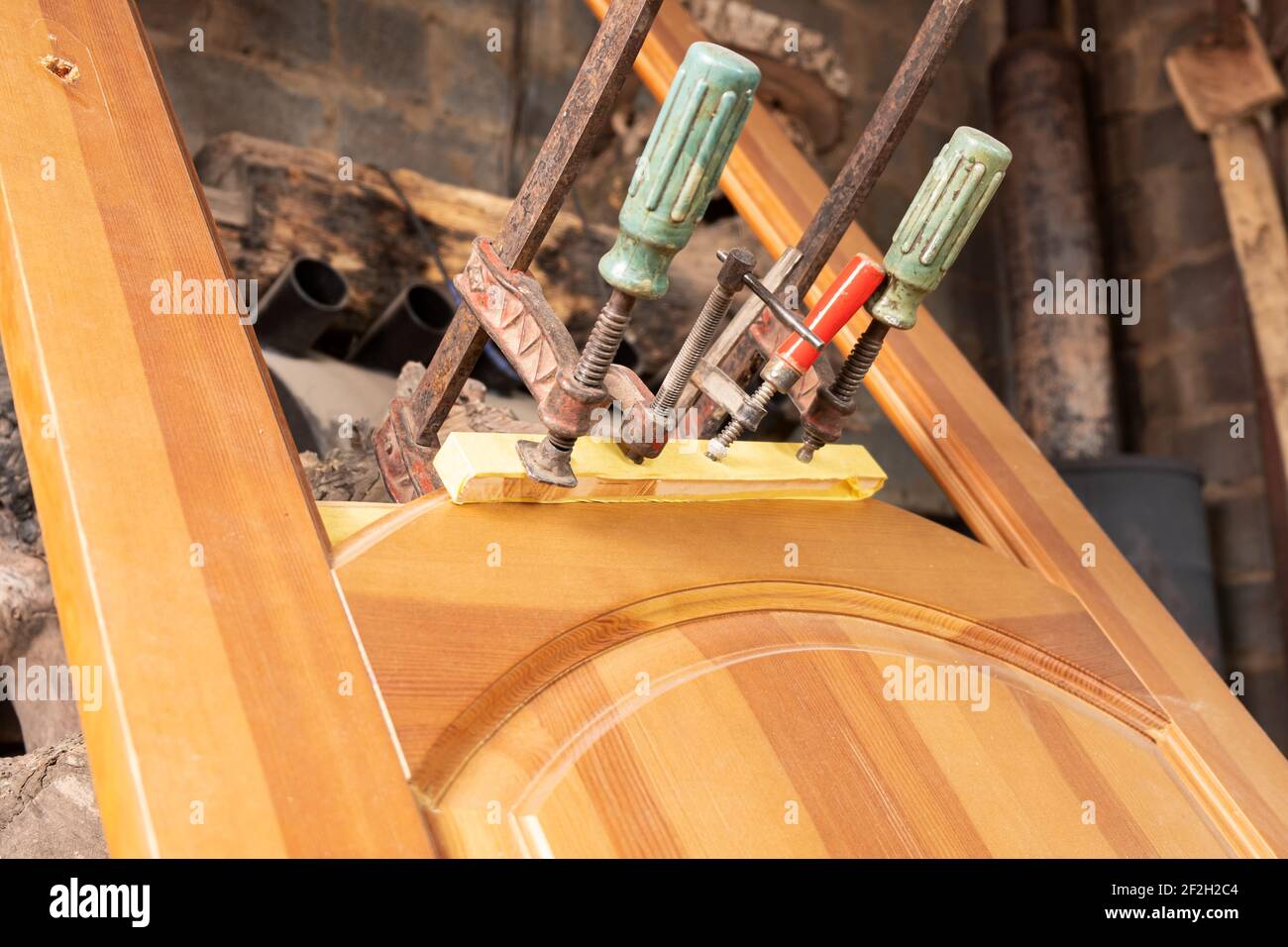 restoration wood repair, gluing doors clamped with clamps Stock Photo Alamy