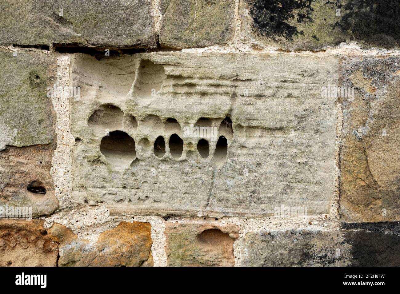 Eroded block of stone in a wall Stock Photo - Alamy