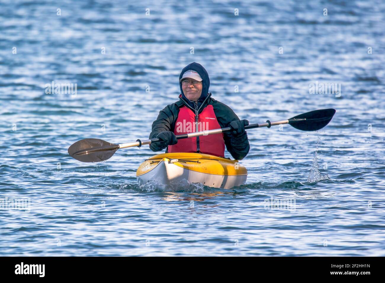 A man in a kayak enjoying a very early season paddle along the