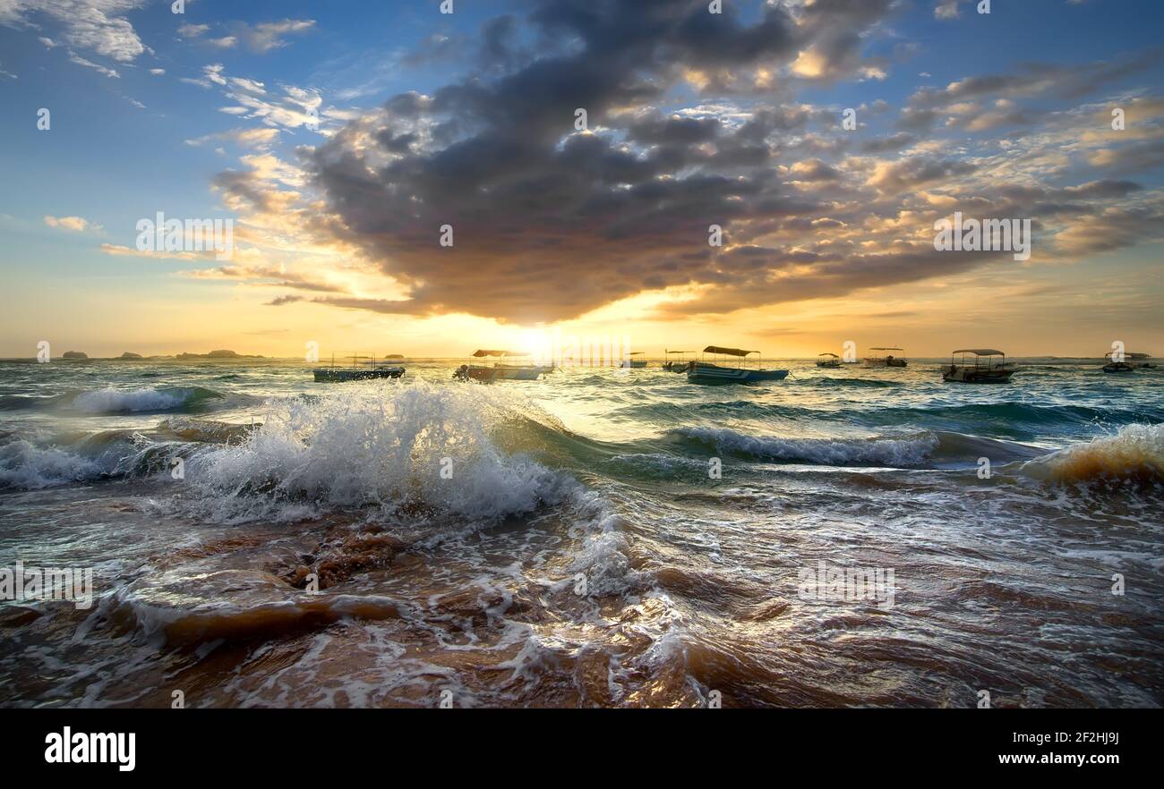 Fishing boats in the ocean at sunset Stock Photo - Alamy