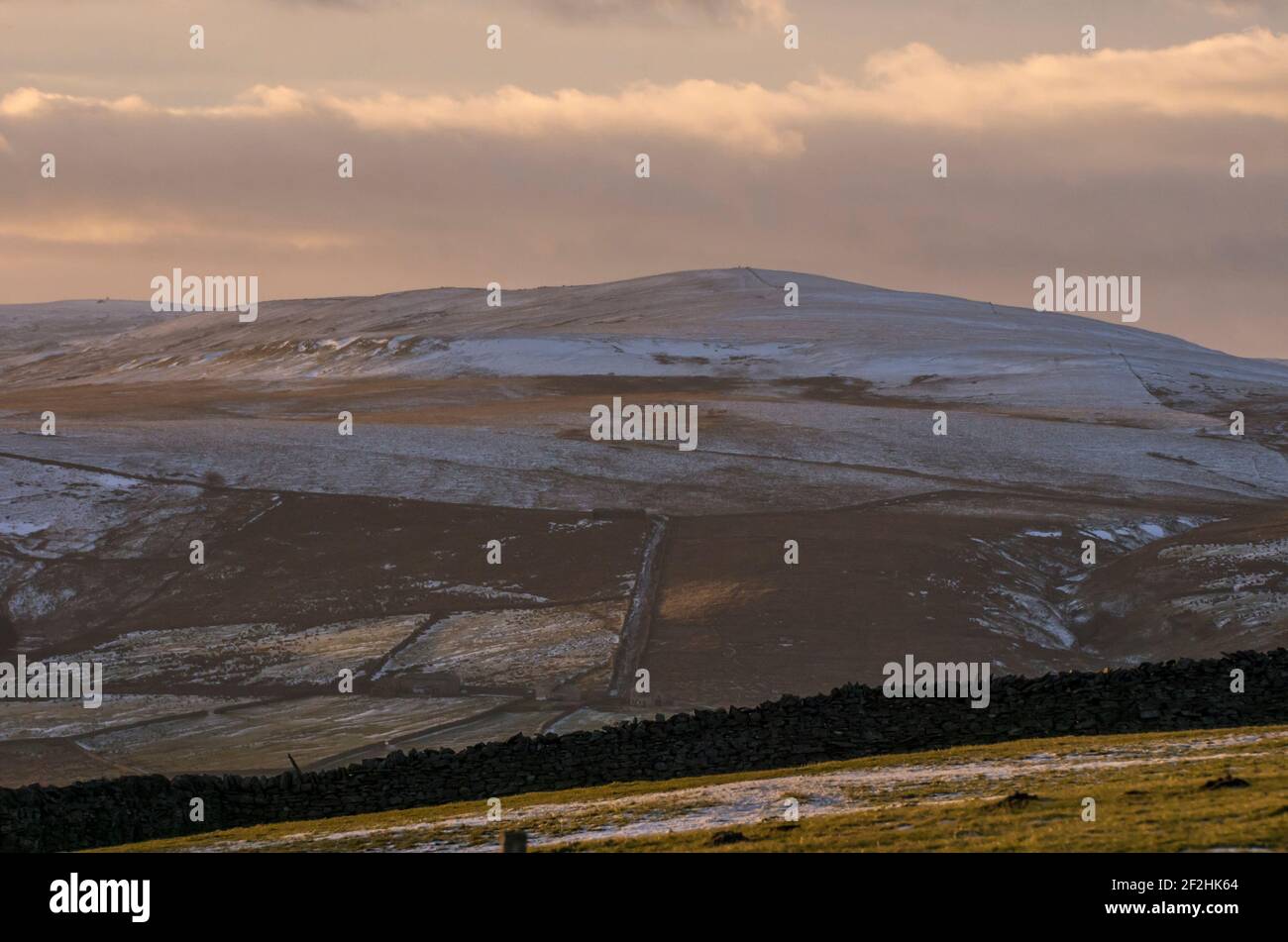 Chapel Fell, a mountain in Weardale, the North Pennines, County Durham, UK, dusted with snow in late afternoon sunlight Stock Photo