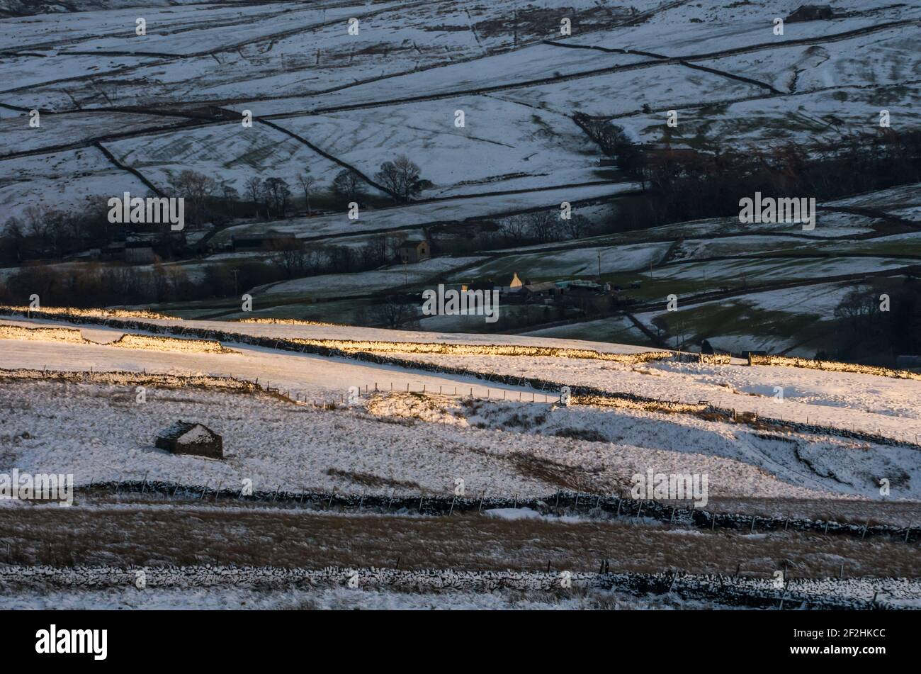 Snow covered hills and fields in late afternoon winter sunlight in Weardale, the North Pennines, County Durham, UK Stock Photo