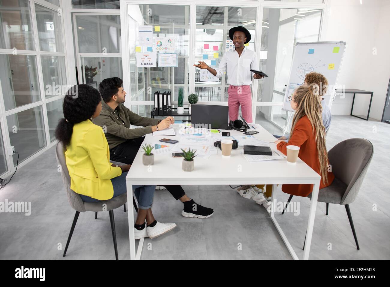 Five creative multiracial young people brainstorming at office Stock ...