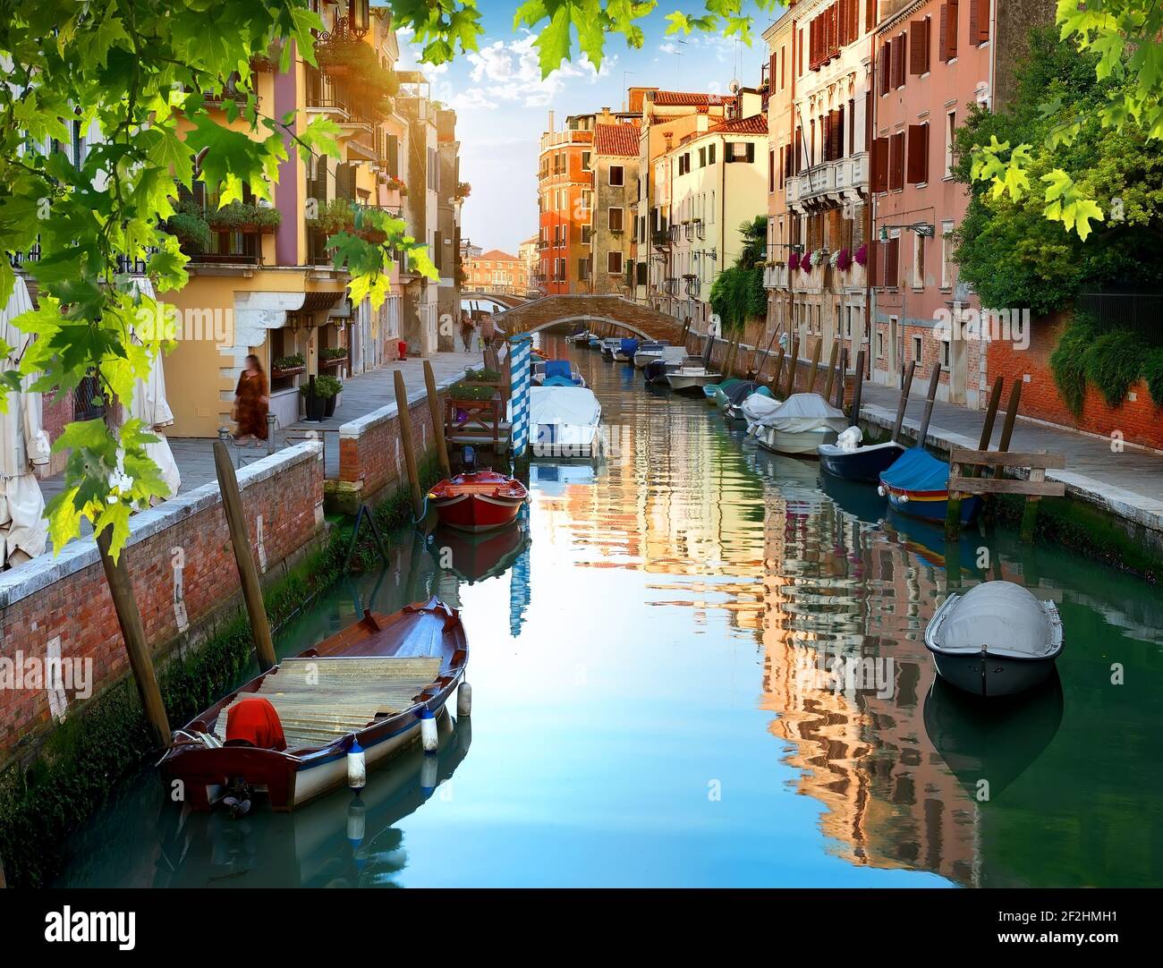 Boats in narrow venetian water canal, Italy Stock Photo