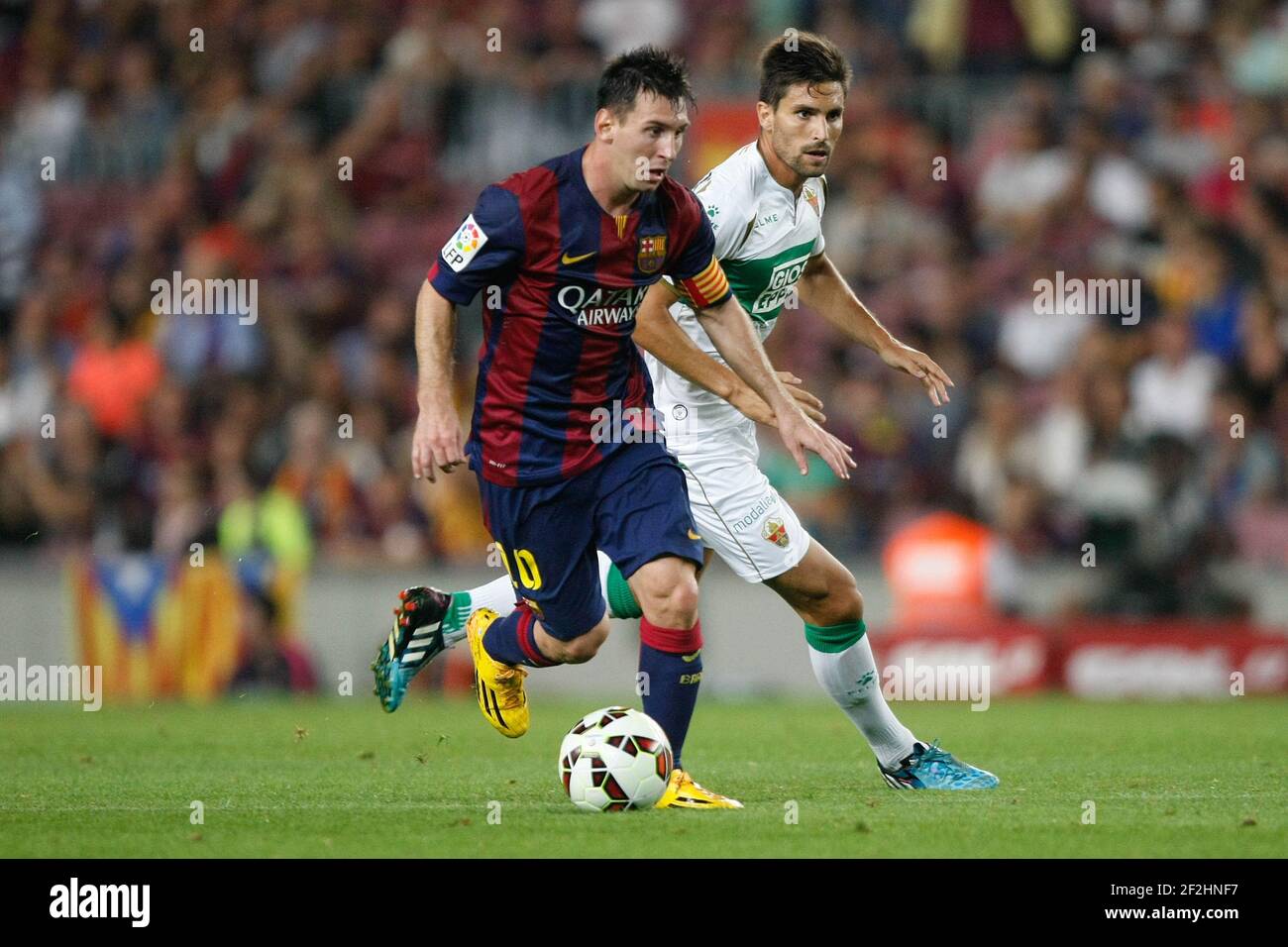 FC Barcelona 3-0 Elche, Leo Messi (BAR) and Jose Angel Alonso (ELC) during La Liga soccer match between FC Barcelona and Elche CF, at the Camp Nou stadium in Barcelona, Spain, Sunday, august 24, 2014. Photo Bagu Blanco / DPPI Stock Photo